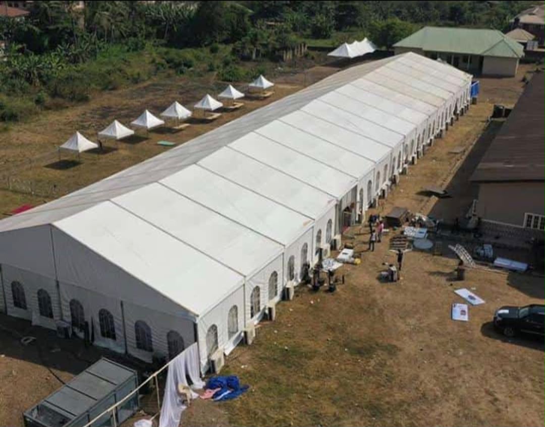Aerial view of a long marquee complex with several smaller pinnacle tents nearby